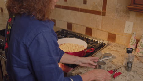 woman using can opener to open a can of ingredients in slow motion