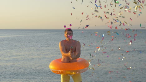 Man-with-confetti-cracker-at-the-seaside