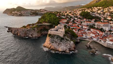 dubrovnik's historic coast at golden hour, featuring stone buildings, aerial view