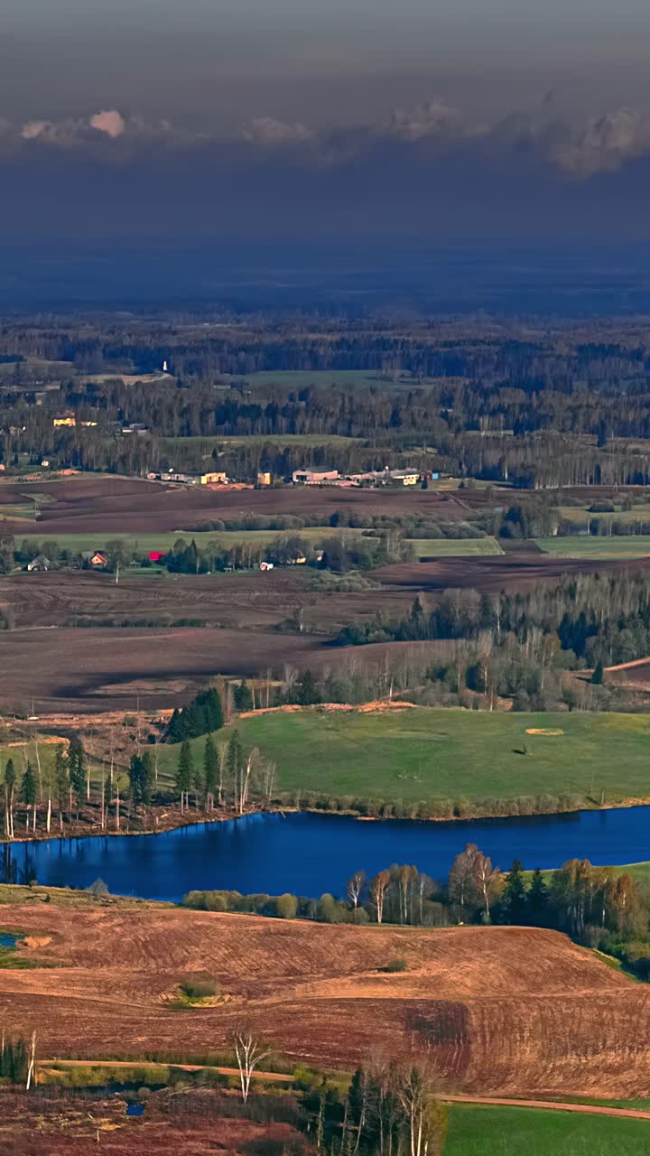 Clouds drifting over a landscape on a dark day in a time-lapse aerial shot
