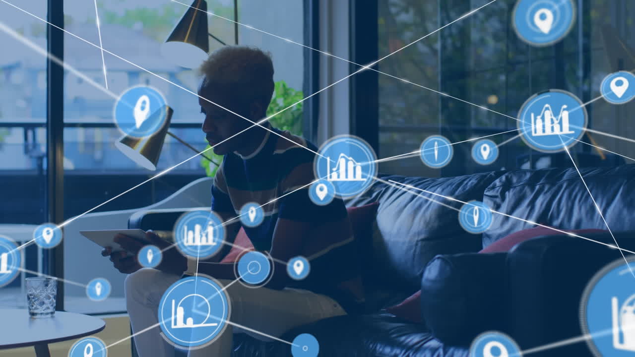 Animation of network of connections with icons over african american businessman