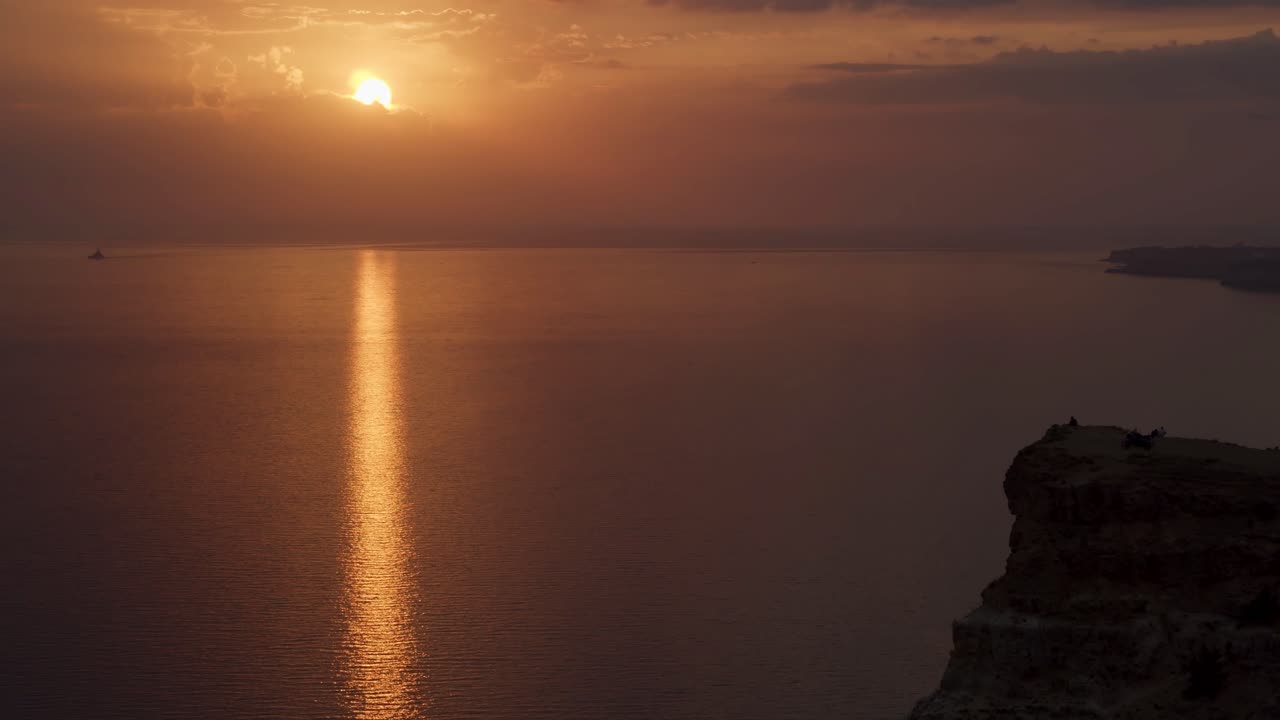 Sunset over the ocean with reflections