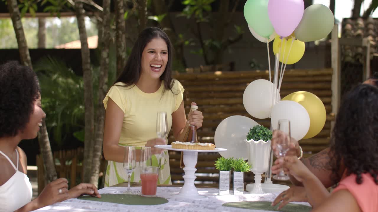 Friends Celebrating Outdoors with Champagne Pop