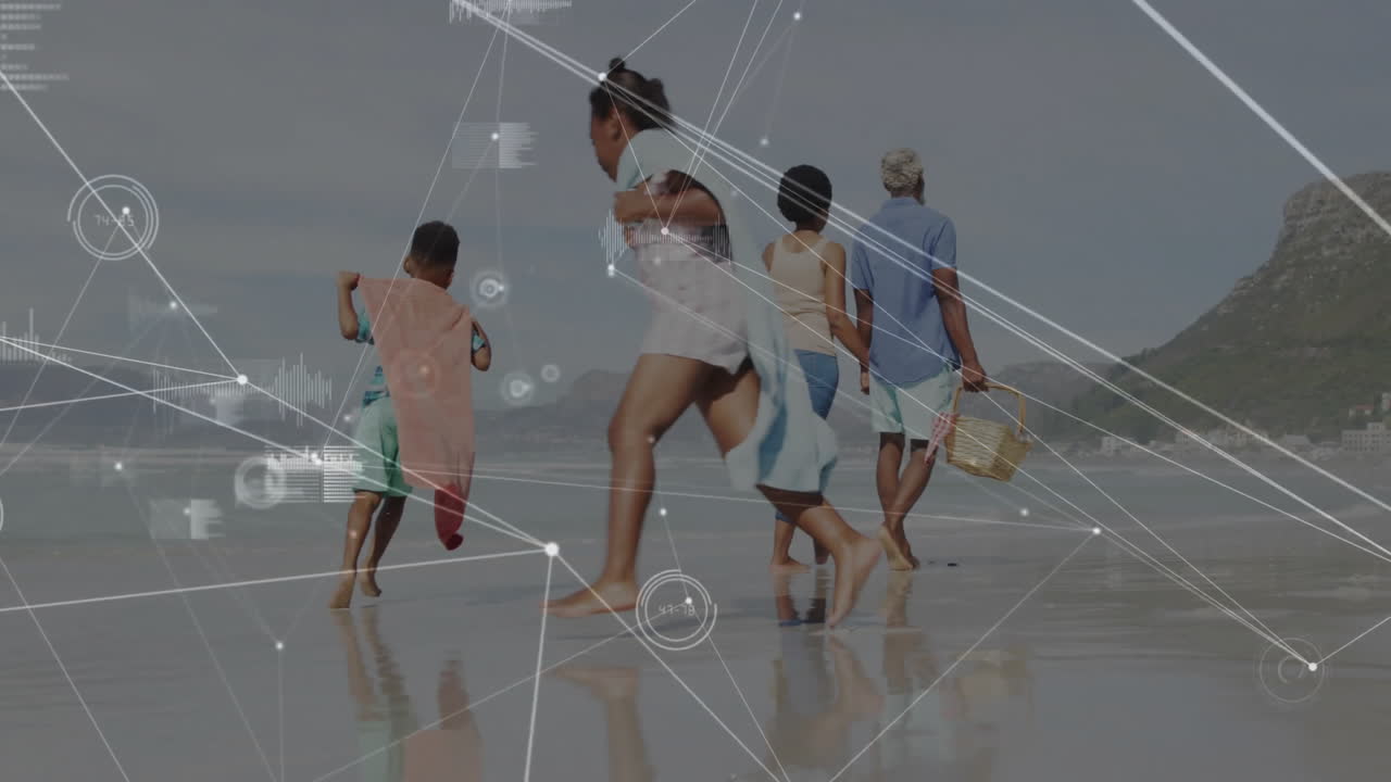 family walking barefoot along wet sandy shoreline, showing technology network lines