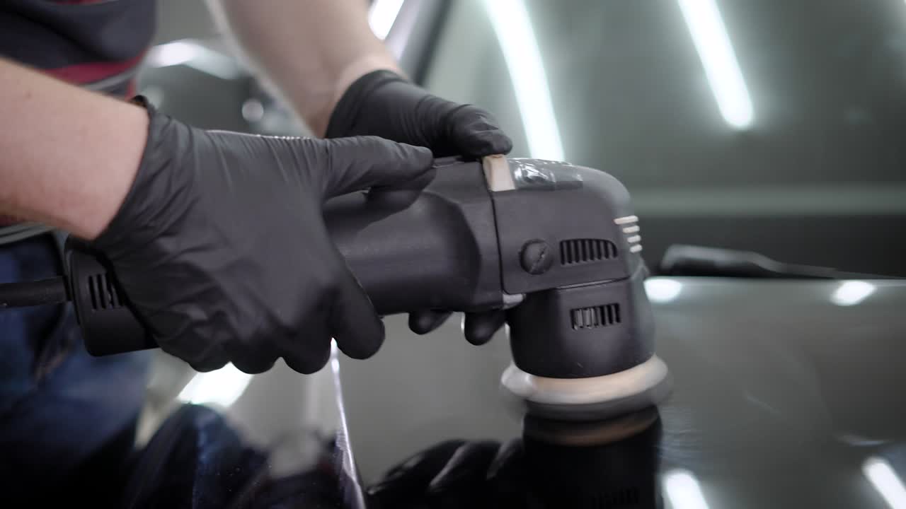 Anonymous person in black gloves holding grinder machine