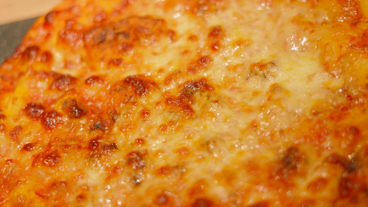 Slow Moving Top View of Delicious Freshly Cooked Italian Cheese and Tomato Margherita Pizza Resting Ready to Eat.