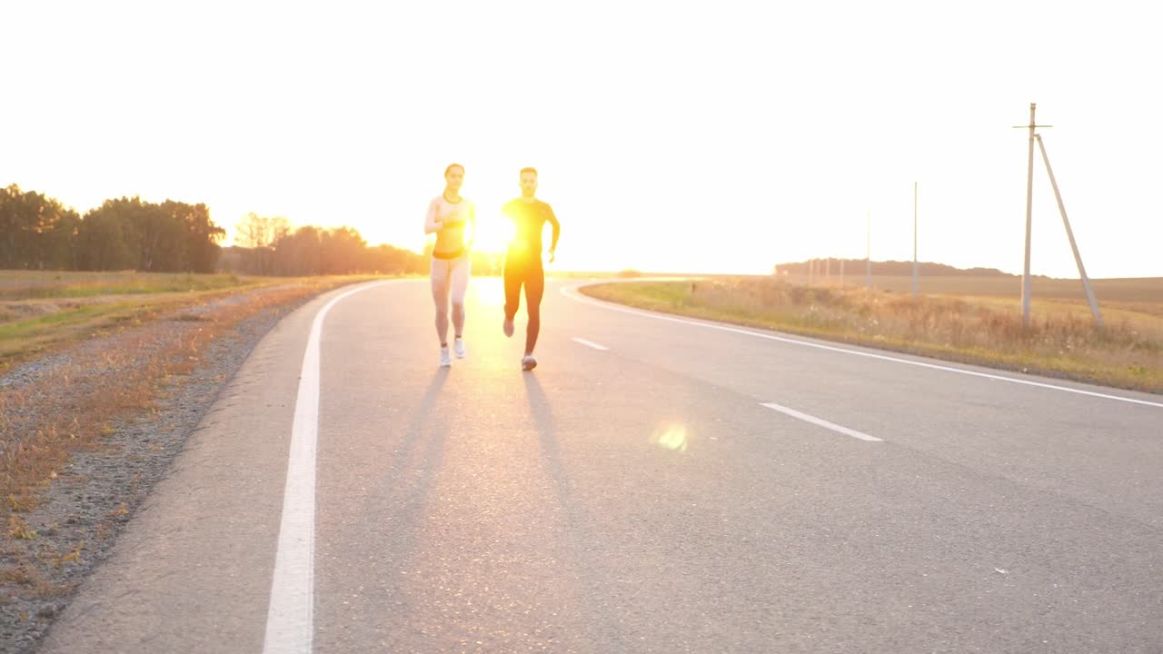 Couple Running on a Road at Sunset