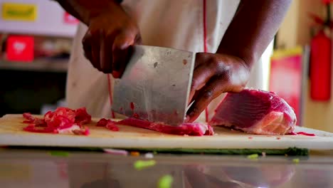 red meat being cut up by african american chef