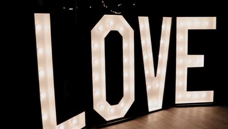 giant love sign lit up with lights at a wedding reception at the strathmere in ottawa, canada