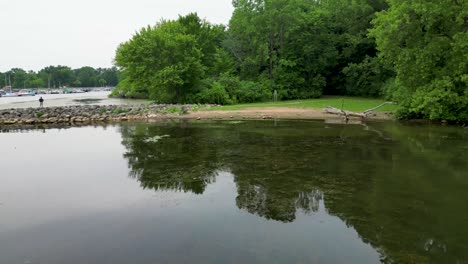 A-tranquil-lake-scene-with-lush-green-trees-reflecting-on-the-water's-surface