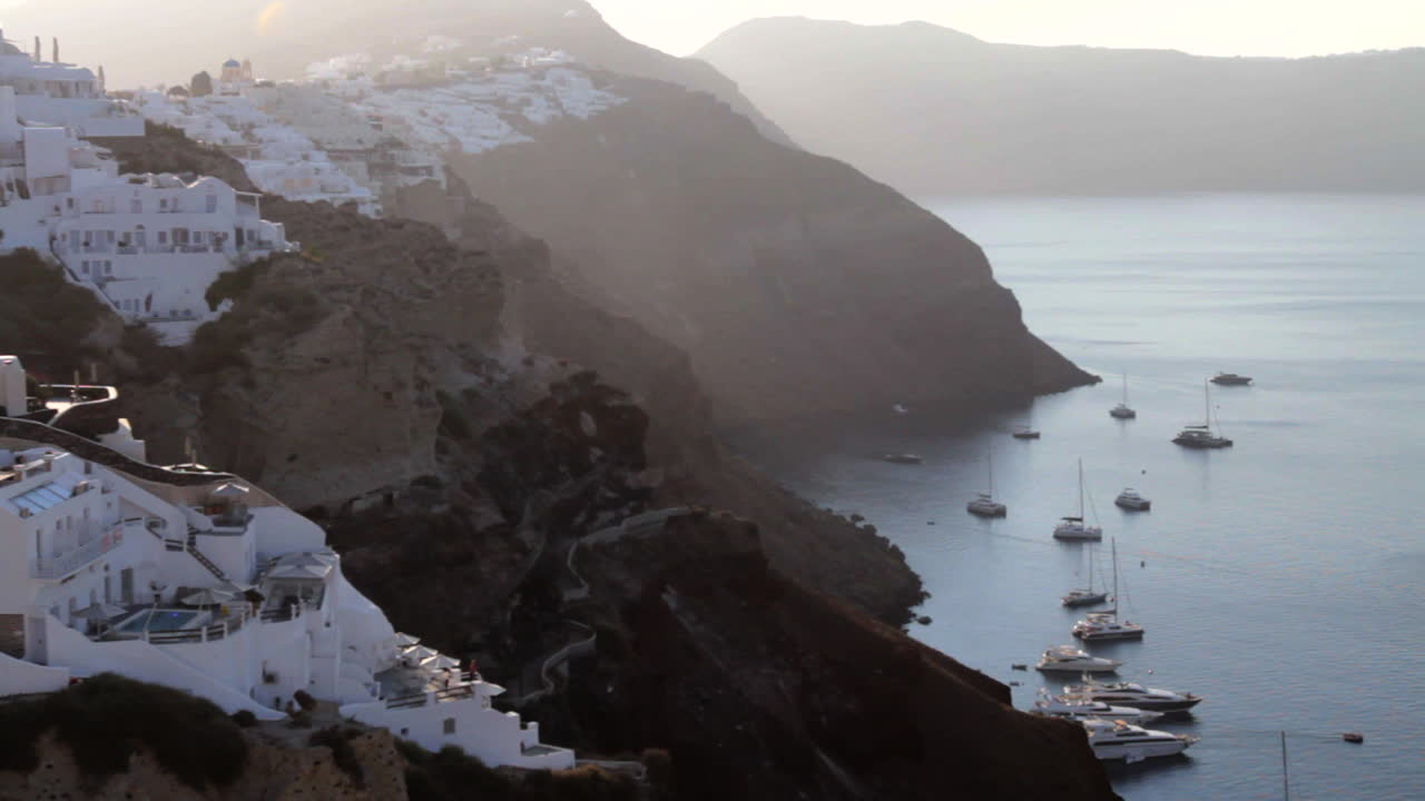 vista del pueblo de oia colgando de los acantilados del paisaje marino de santorini