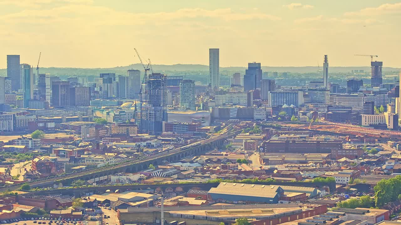 Aerial Perspective of Birmingham City Centre Showing Modern Architecture and Urban Development Under a Warm Sunny Sky, drone slow ascending