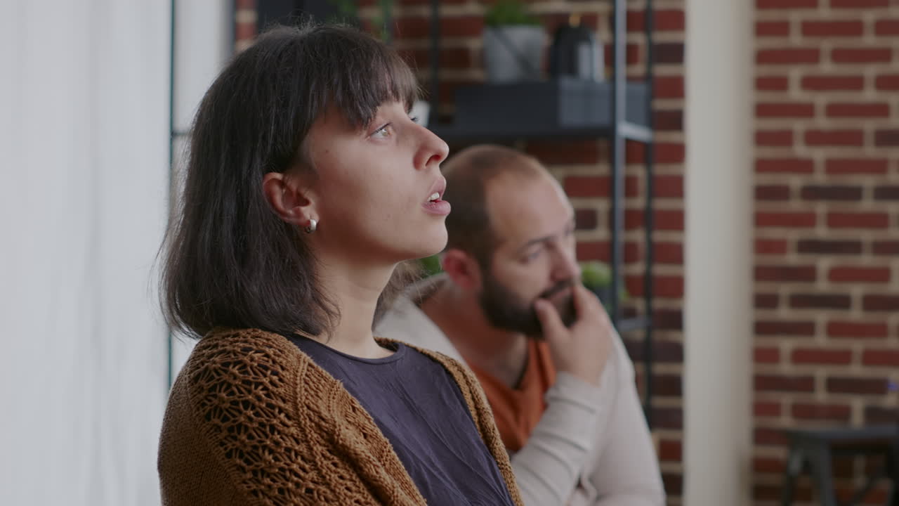 Close up of woman with addiction crying and having nervous reaction at aa group meeting