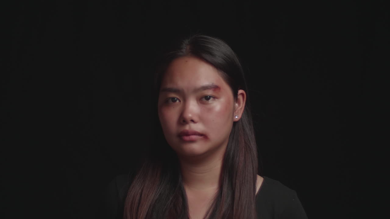 Abused Woman With A Bruised The Victim Of Domestic Violence With Black Background