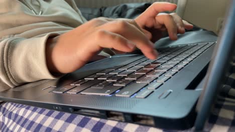 detail of laptop keyboard and writing fingers or hands, wide angle rare view in slow motion