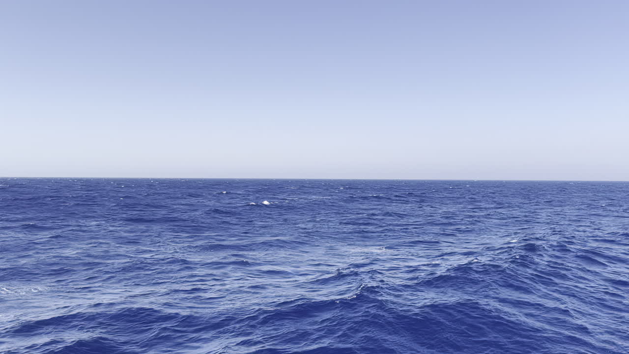 Red Sea endless ocean waves rolling with a camera pan from boat