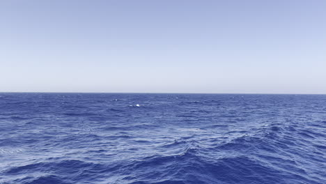 red sea endless ocean waves rolling with a camera pan from boat