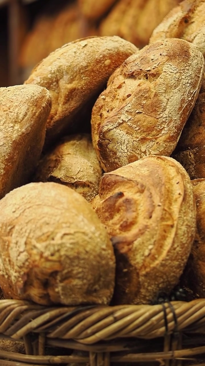 Freshly Baked Artisan Bread Loaves in a Wicker Basket
