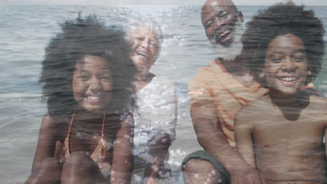 animation of happy african american family sitting at beach over sea