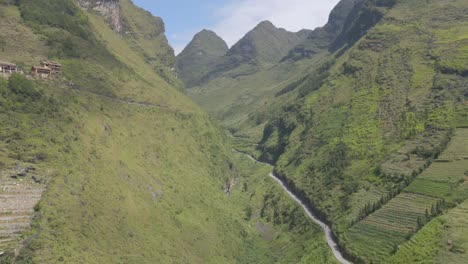 drone flies downward to the magnificent mountain pass between green mountain range