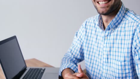 Men-with-hands-joined-smiling-at-camera