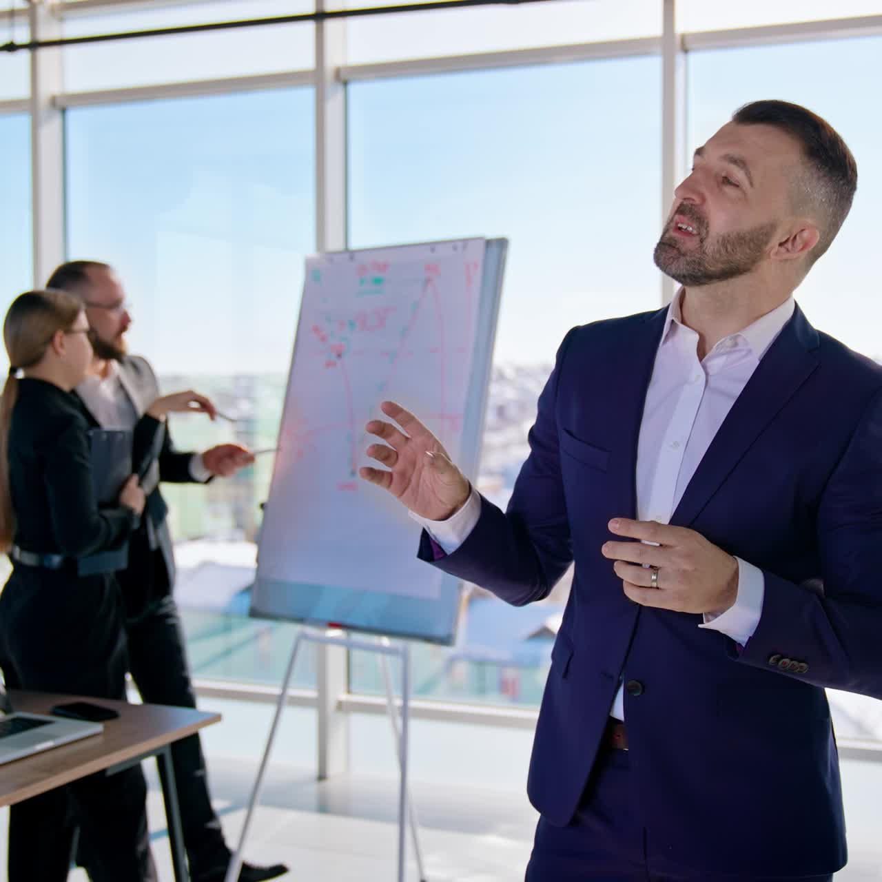 Entrepreneur talking on business in office. Business people working in the modern agency with large windows with city background