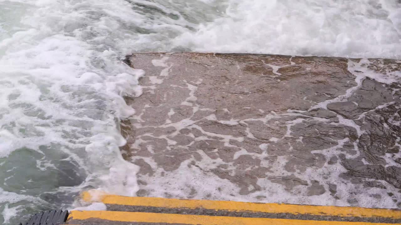Strong sea currents splash water at the harbor waterfront as a severe tropical typhoon storm, which sustained winds of 63 miles , travels through the city of Hong Kong
