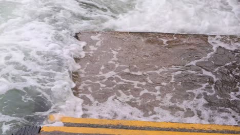 strong sea currents splash water at the harbor waterfront as a severe tropical typhoon storm, which sustained winds of 63 miles , travels through the city of hong kong