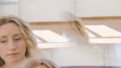 caleidoscopic effect of a focused blond woman performing a contemporary dance in the studio