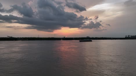 Aerial-view-of-working-boat-on-the-Mississippi-River-at-sunset