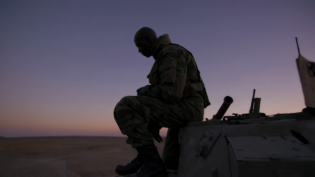Soldier on Tank at Sunset in Desert