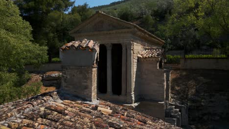 Aerial-View-Of-Temple-of-Clitumnus,-Flying-Over-Roof-Tiles-And-Chimney