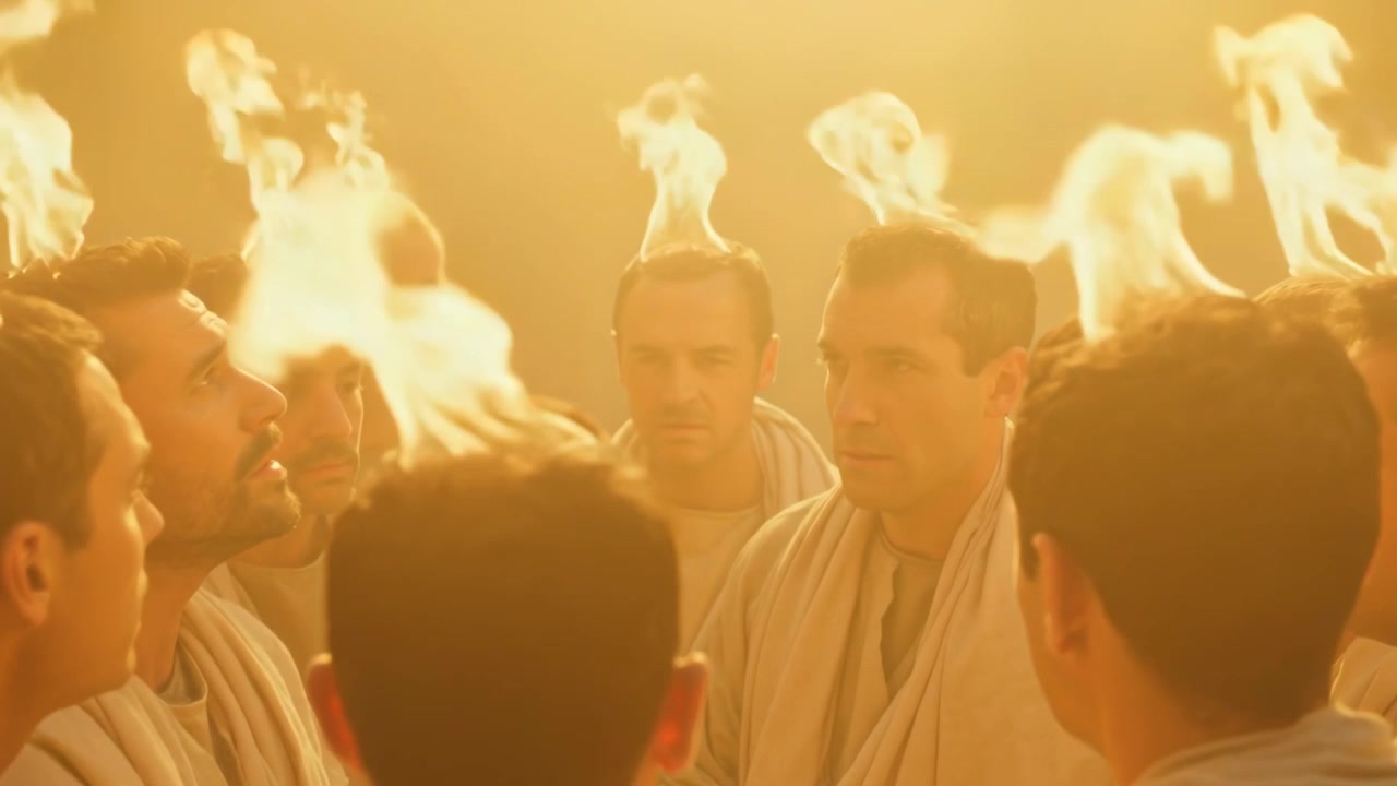 Ring of robed men standing close performing solemn ritual in chamber, flames igniting above heads