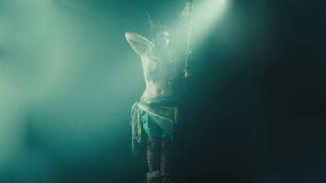 the witch makes a gesture of cutting her throat