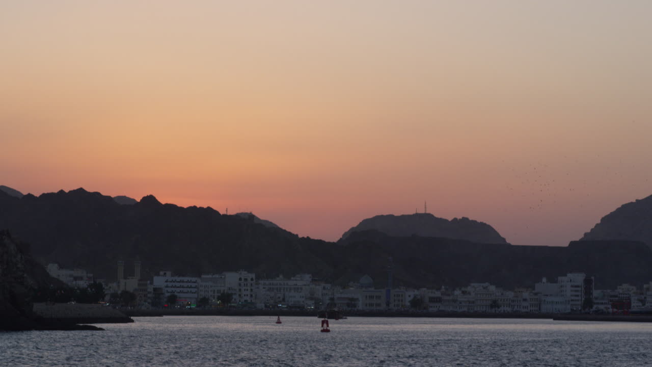 The hills and mountains of Muscat, Oman at sunset, wide shot tilt down