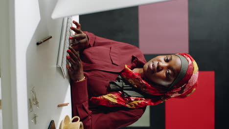 muslim woman in red posing at desk vertical