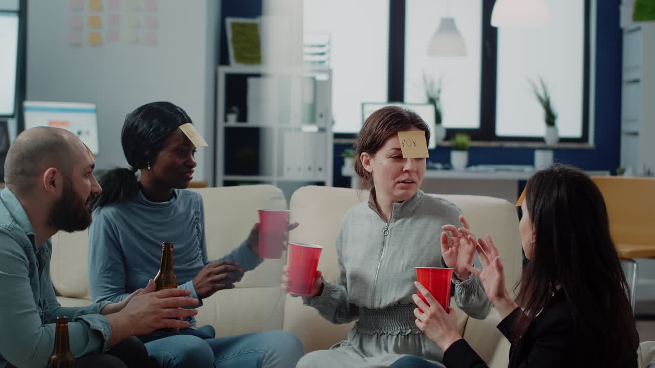 Cheerful coworkers play guessing game with drinks