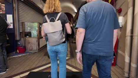 people entering from the street into english market building in cork city, ireland