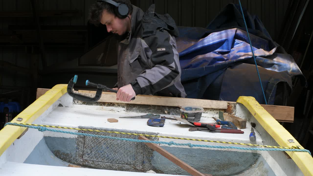 Removing Clamp from Fibreglass Boat Transom in Workshop