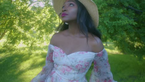 black young woman on picnic in park looking up tilt close up