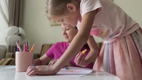 mother and daughter drawing together