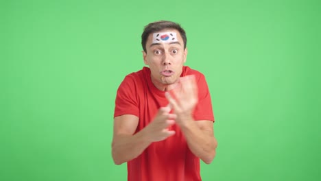 man cheering for south korea, angry with the decision of referee