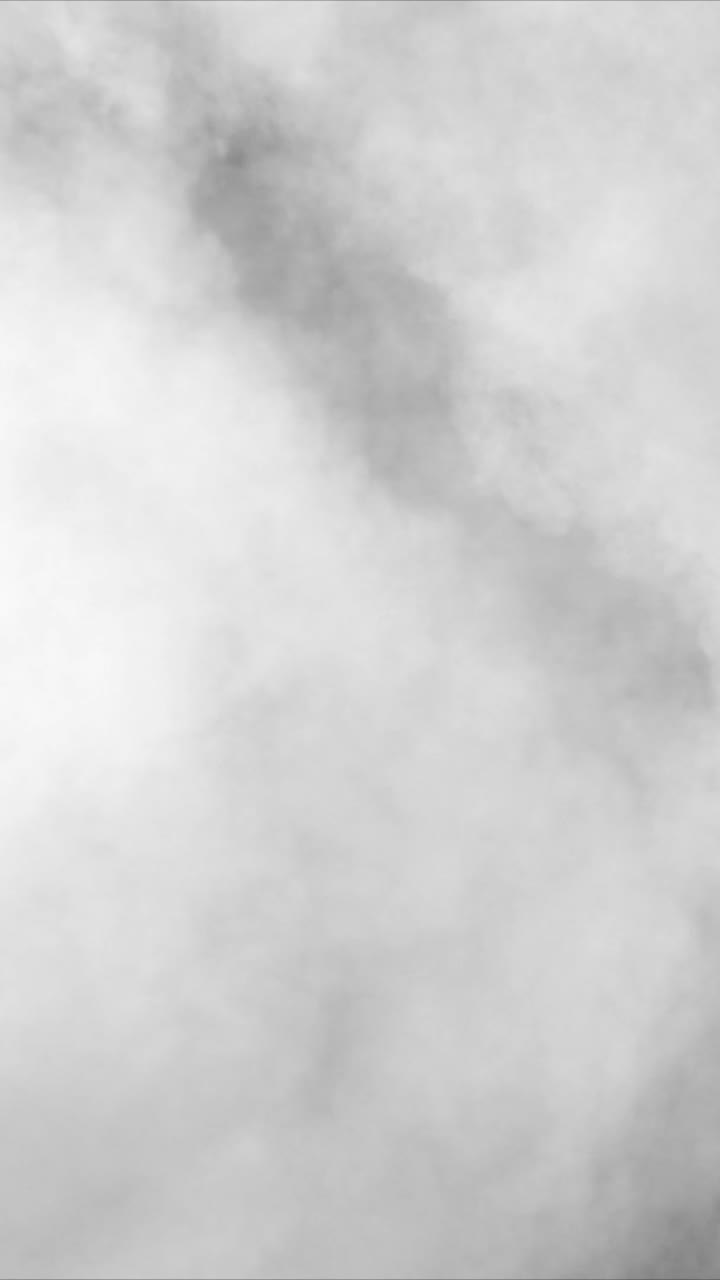 A dense, bright white fog or smoke texture fills the vertical frame. Ideal for creating a "whiteout" effect, transitions, or clean, ethereal scenes