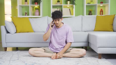 Cozy-home,-young-man-talking-on-the-phone.