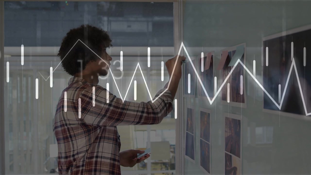 Designer studying grid on glass planning layout placing notes while using phone waveforms reacting