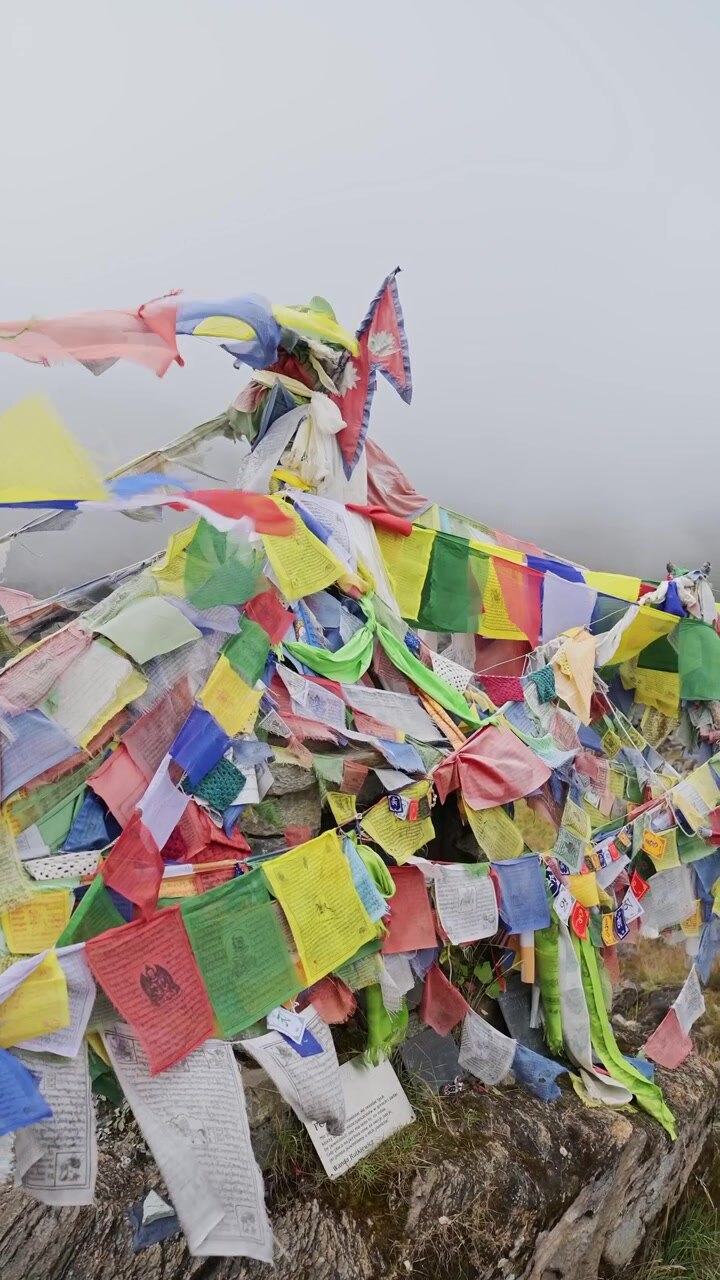 Vertical Buddhist Prayer Flags Close Up in Misty Mountains in Nepal, Vertical Video for Social Media Instagram Reels and Tiktok of Colourful Prayer Flags in Mist in the Himalayas Blowing in the Wind