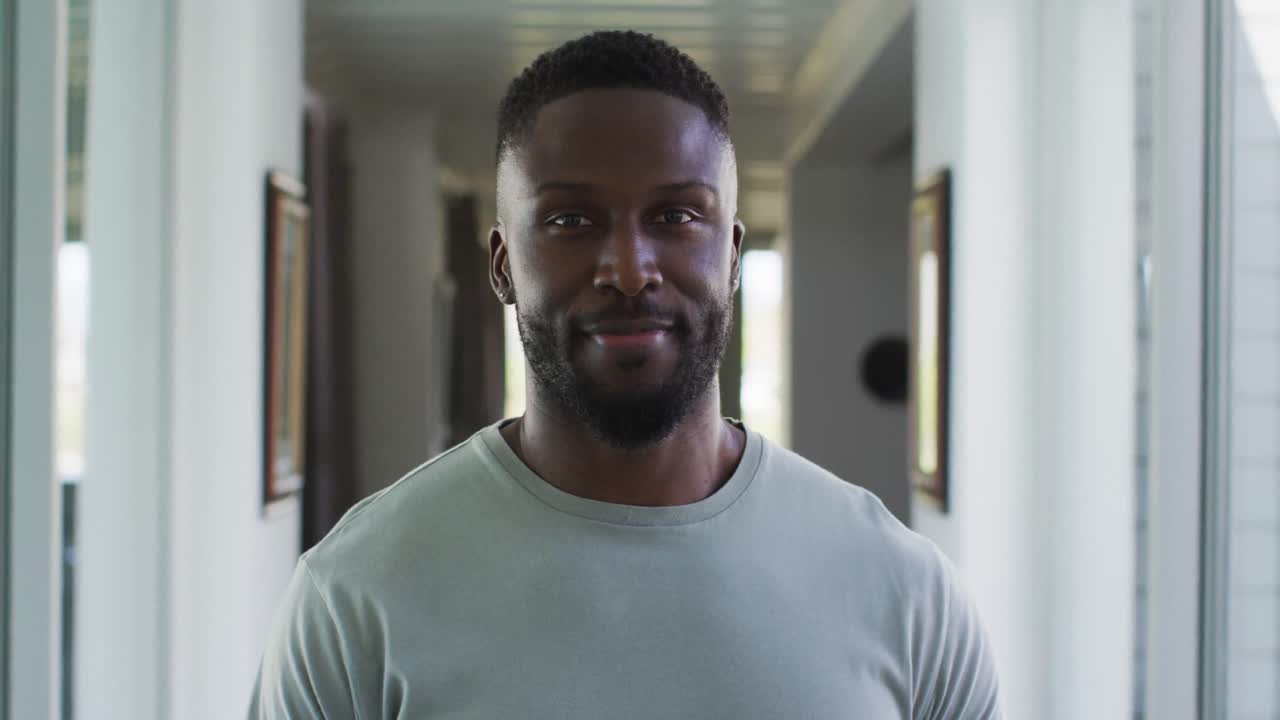 Portrait of african american man smiling while standing at home