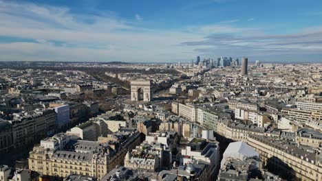 triumphal arch or arc de triomphe with montparnasse tower and la defense skyscrapers in background, paris urbanscape, france