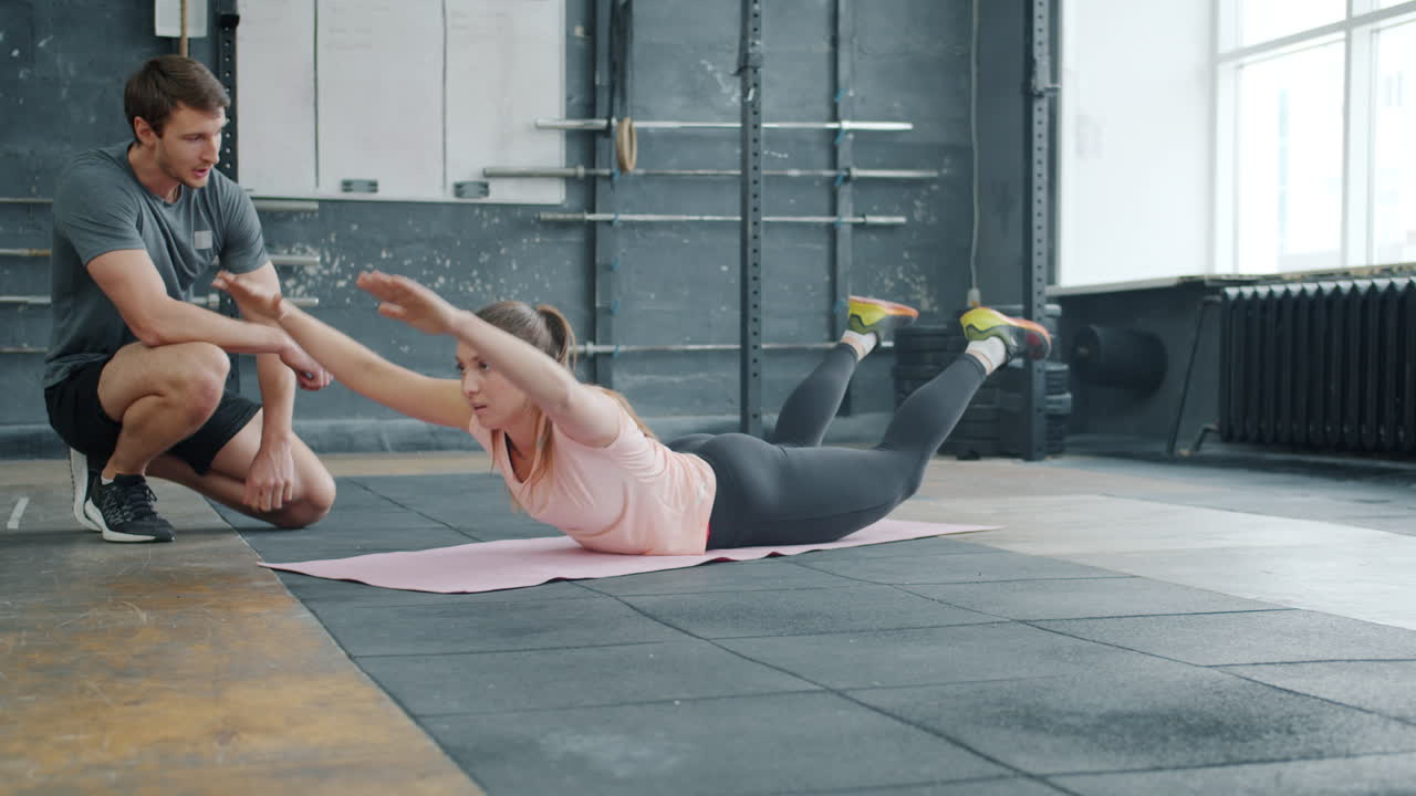 Fitness Instructor Guiding Woman Through Exercise