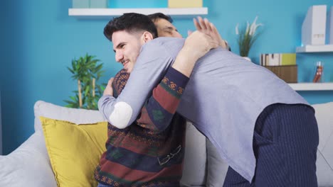 Young-son-kissing-his-father's-hand.